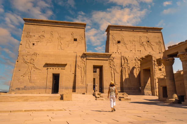 A young tourist visiting the Temple of Philae – shot from behind