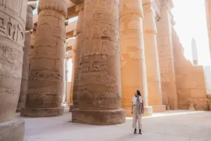 woman walking through the luxor temple